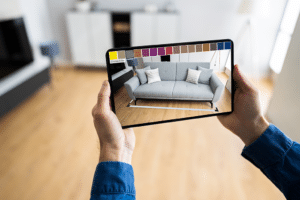 person holding mobile device in room to show augmented reality couch in living room