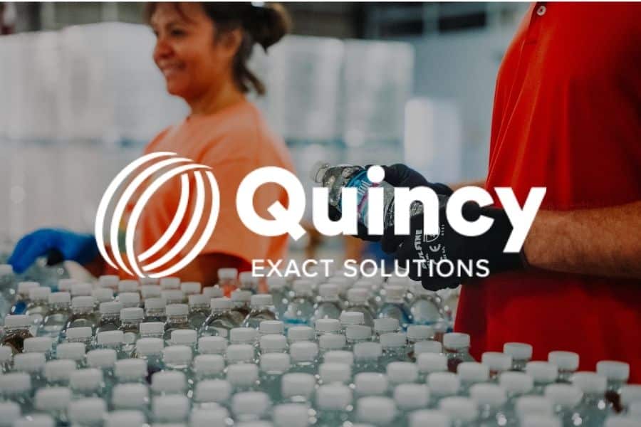 woman smiling and working at Quincy Exact Solutions
