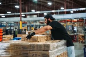 man packaging boxes in warehouse